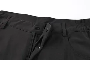 Detail view of men's outdoor shorts featuring snap button and elastic waistband