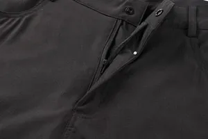 Detailed view of the functional zipper and button closure on black men's outdoor shorts