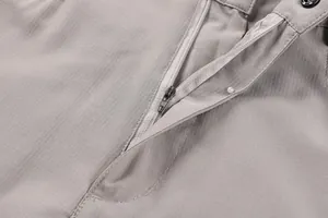 Close-up of durable metal zipper fly on grey men's tactical cargo shorts