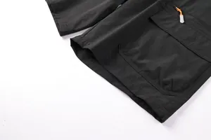 Detailed close-up of black men's outdoor casual shorts featuring side pocket and zipper