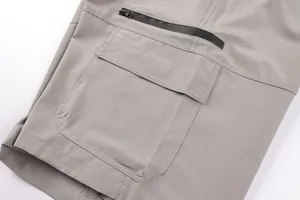 Close-up of side pockets on men's grey functional cargo shorts for outdoor wear