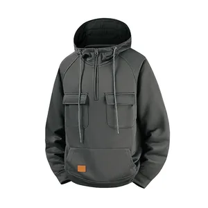 Detail of men's vintage charcoal grey half-zip hoodie featuring functional tactical pockets