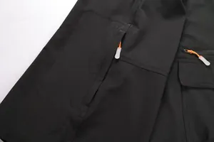 Close-up of durable ripstop fabric and zipper pockets on black outdoor sports shorts