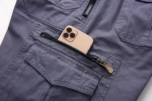 Detalle del bolsillo grande con cremallera en los pantalones cortos cargo grises