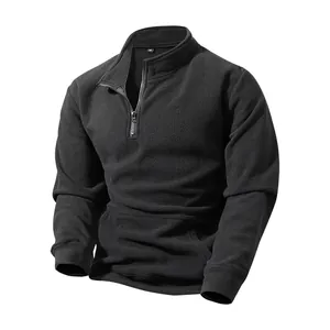 Macro view of men's solid color half-zip fleece sweatshirt showing warm fabric texture