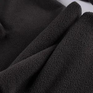 Macro view of high-quality soft black polar fleece fabric showing thick cozy texture