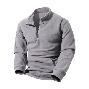 Close-up of grey men's half-zip fleece pullover showing soft texture and zipper