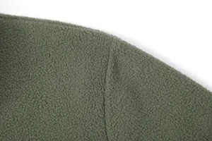 Close-up of olive green fleece material showing soft texture and shoulder seam detail