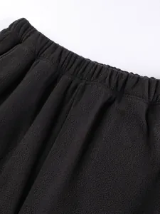 Men's thick black polar fleece sweatpants shown from a close-up angle of the waistband