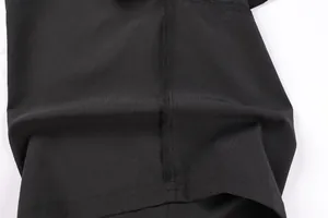 Macro view of high-quality stitching and breathable fabric on black sports shorts