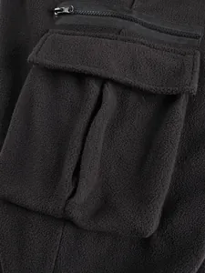 High quality detail of the functional cargo pocket on men's thick black polar fleece pants