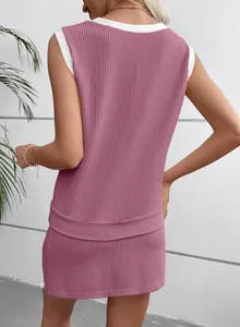 Detail back view of a pink ribbed knit two-piece summer set with white contrast trim