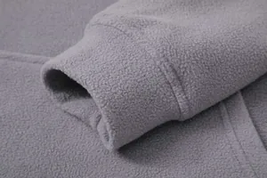 Macro detail of soft grey fleece fabric and elastic cuff on men's warm sweatshirt