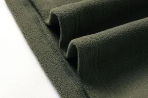 Macro dettaglio di morbido tessuto pile verde militare con trama spessa e cuciture sull'orlo