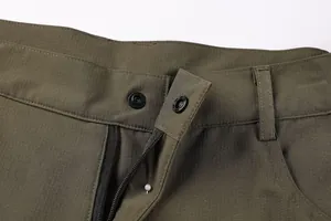 Detailed view of the button closure and ripstop texture on men's outdoor cargo shorts
