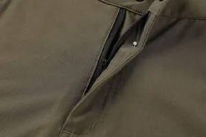 Close-up of olive green ripstop fabric and zipper detail on men's outdoor cargo shorts.