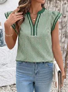Detalle de la blusa de rayas verticales verdes y blancas con cuello V y mangas con volantes.