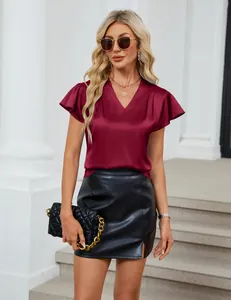 Close-up detail of elegant burgundy V-neck satin blouse featuring pleated short sleeves