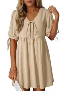 Detailed view of textured cream V-neck mini dress with puff sleeves and elegant bow tie front