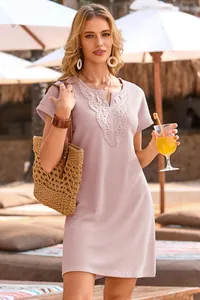 Lifestyle detail of pink waffle knit dress featuring lace V-neck trim and casual short sleeves