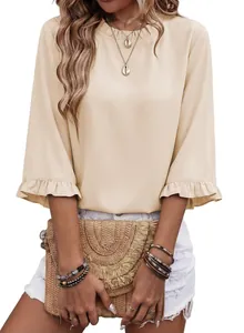 Detailed macro view of the ruffle collar and half sleeves on this elegant beige summer blouse