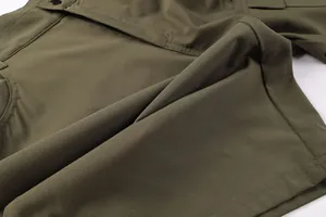 Close-up of high-quality olive green ripstop fabric on men's outdoor cargo shorts
