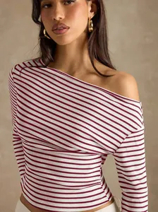 Detail of striped off-the-shoulder long sleeve top with ribbed texture and slim fit