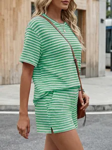 Detailed view of a fashionable green striped short-sleeve tee and side slit shorts set