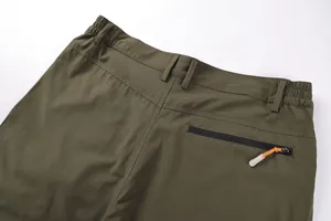 Close-up of back zipper pocket and elastic waist on olive green cargo shorts for men
