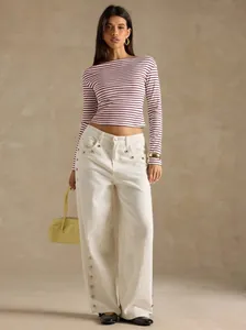Chic striped boat neck long sleeve T-shirt styled with white wide-leg pants for autumn