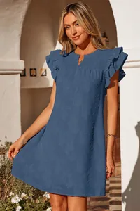 Close-up detail of blue floral mini dress featuring ruffles and shirred V-neckline