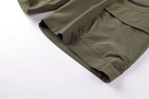 Detail of olive green men's cargo shorts showing textured fabric and pocket stitching