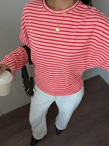 Close-up detail of the pink and red striped batwing long-sleeve T-shirt in a casual style