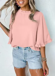 Macro detail of summer pink round neck blouse with elegant ruffle trim on sleeves and collar