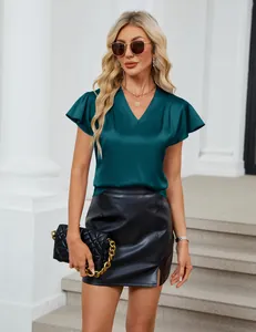 Detailed macro view of a teal V-neck blouse with elegant flutter sleeves and silky texture