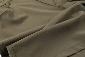 Close-up of olive green ripstop fabric on men's tactical cargo shorts with fine stitching.