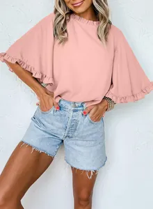 Close-up of pink ruffle sleeve blouse with round neck for a stylish summer look.