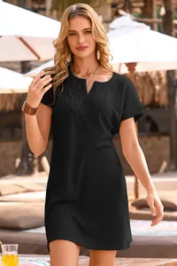 Close-up of black waffle knit dress with elegant lace V-neck detail and short sleeves