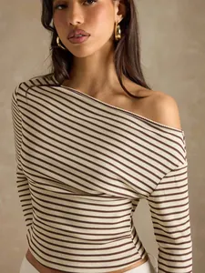 Close-up of striped off-the-shoulder long sleeve top with ribbed fabric texture