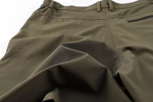 Macro detail of olive green micro-grid ripstop fabric on men's outdoor casual shorts