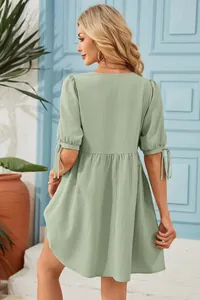 Back view of a summer light green V-neck dress featuring stylish tie-up bubble sleeves