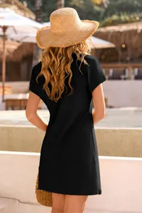 Detailed back view of a black waffle knit mini dress perfect for beach cover-up wear