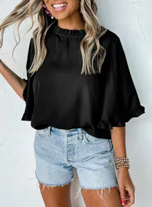 Close-up of stylish black summer shirt featuring ruffle neck and short sleeve ruffle details