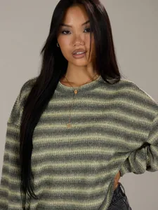 Detailed view of fashionable green striped oversized crewneck sweatshirt on an Asian model