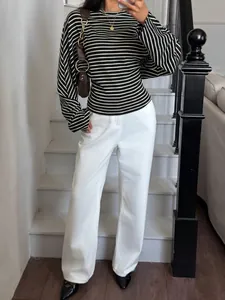 Chic striped long sleeve batwing top styled with elegant white wide leg trousers.