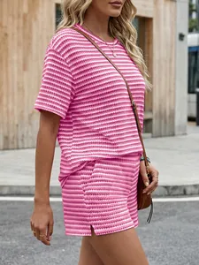 Side view of pink and white striped two-piece short set with side slit detail.