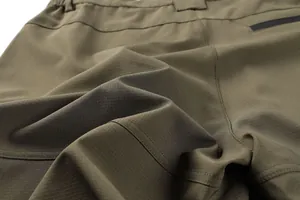 Close-up of olive green ripstop fabric and stitching on men's tactical cargo pants