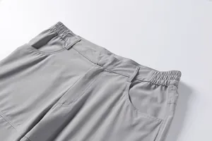 Close-up of elastic waist and pocket detail on grey outdoor men's leisure shorts.
