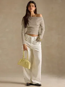 Elegant striped off-the-shoulder long sleeve T-shirt styled with white wide-leg trousers.