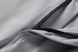 Detailed close-up showing the high-quality zipper and durable ripstop fabric on grey outdoor shorts